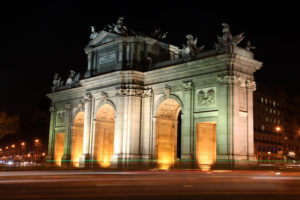 Night view of the Puerta de Alcalá (Alcala Gate) in the Plaza de la Independencia (Independence Square) in Madrid, Spain. Traffic blurr in foreground.