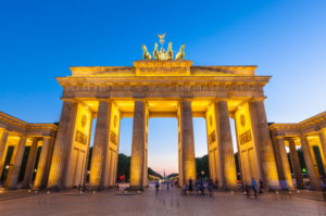 Pretty night time illuminations of the Brandenburg Gate (1788) inspired by Greek architecture, built as a symbol of peace and nationalism, now an emblem of reunification.